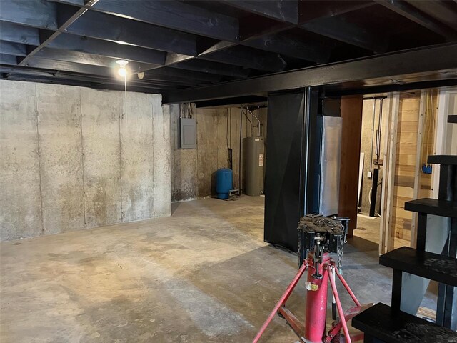 basement featuring water heater and electric panel