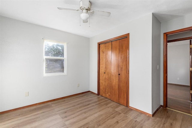 unfurnished bedroom with light hardwood / wood-style flooring, a closet, and ceiling fan