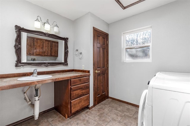 bathroom featuring sink and separate washer and dryer