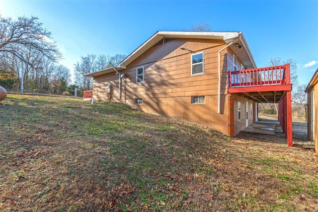 view of home's exterior featuring a lawn and a wooden deck