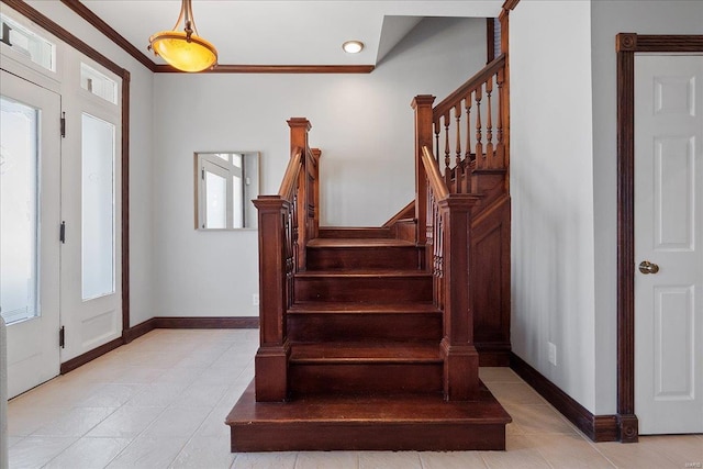 foyer entrance featuring light tile patterned floors, stairway, and baseboards