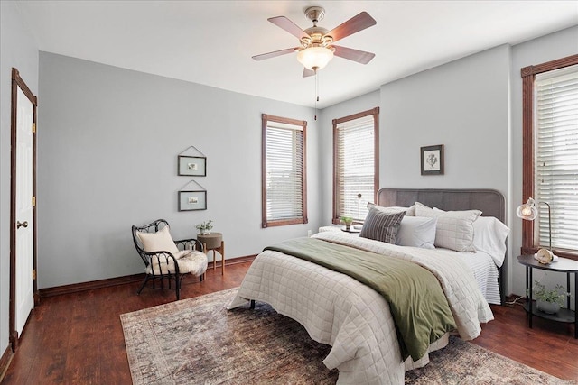 bedroom with ceiling fan, baseboards, and wood finished floors