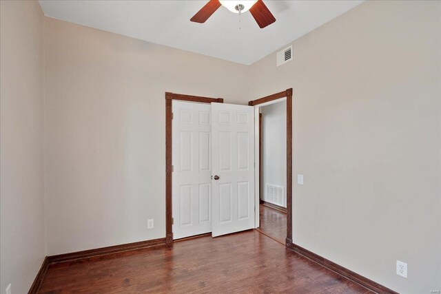 empty room with visible vents, baseboards, and wood finished floors