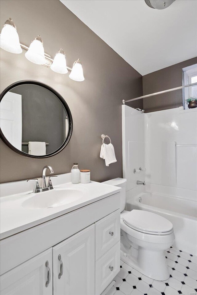 bathroom with vanity, toilet, and tub / shower combination