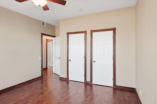 unfurnished bedroom with ceiling fan, wood finished floors, visible vents, and baseboards