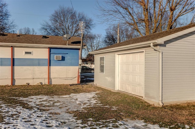 view of snowy exterior with a garage