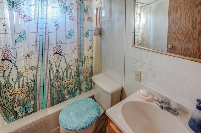 bathroom with sink, tasteful backsplash, toilet, and tile walls