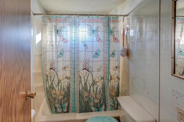 bathroom featuring toilet and a shower with curtain