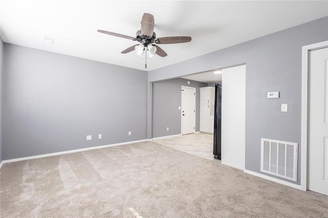 carpeted spare room with ceiling fan