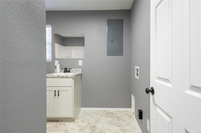 washroom featuring cabinets, sink, electric panel, and hookup for a washing machine