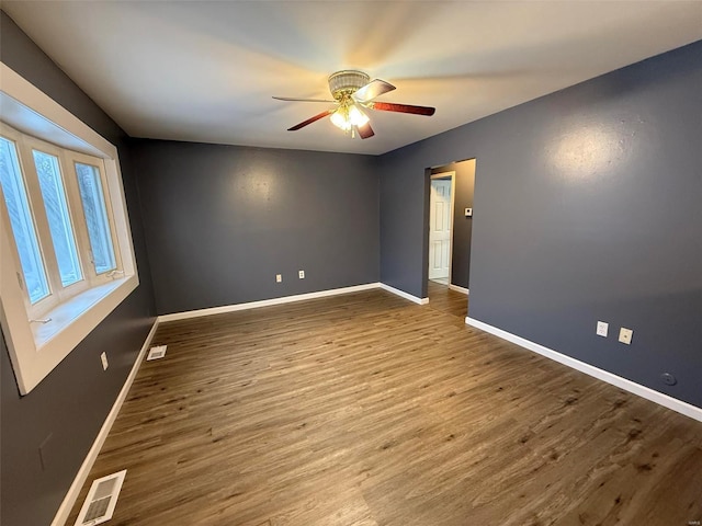 unfurnished room with ceiling fan and hardwood / wood-style floors