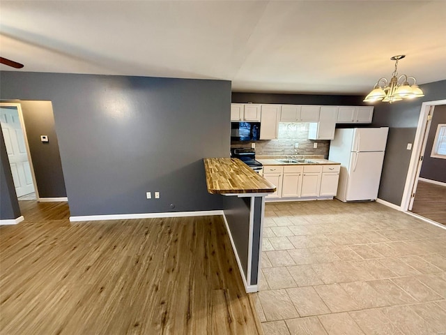 kitchen with wood counters, white cabinetry, backsplash, white fridge, and electric stove