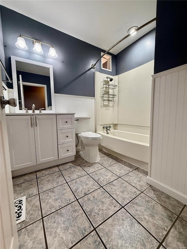 full bathroom featuring tile patterned flooring, toilet, vanity, and  shower combination