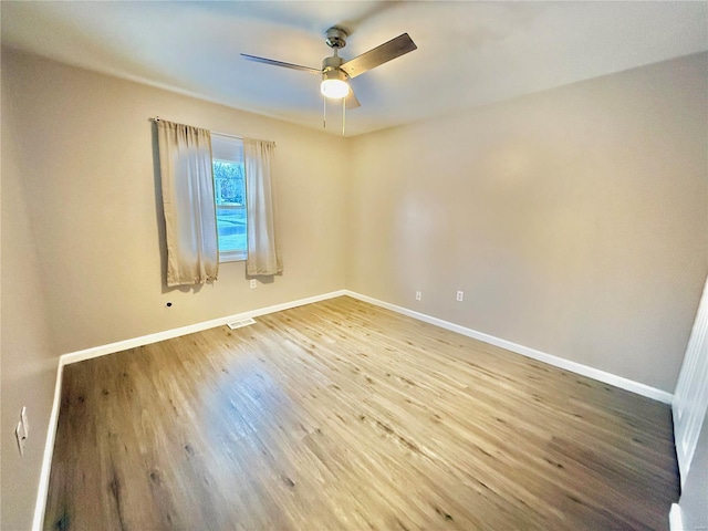 spare room featuring hardwood / wood-style flooring and ceiling fan