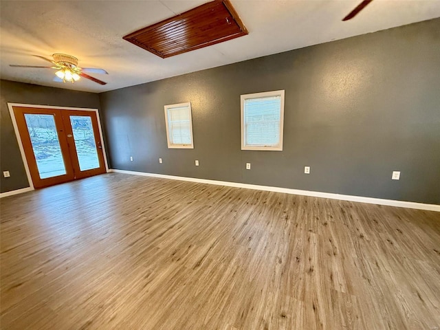 unfurnished room featuring french doors, ceiling fan, and light hardwood / wood-style floors