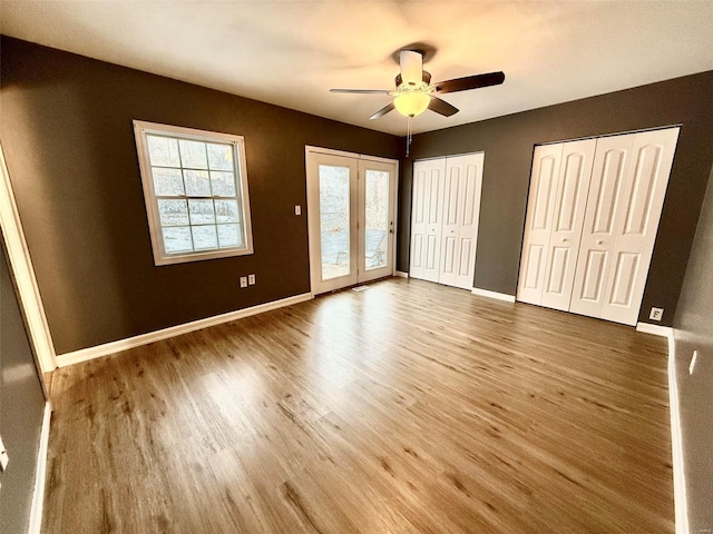 interior space with ceiling fan, wood-type flooring, and access to exterior