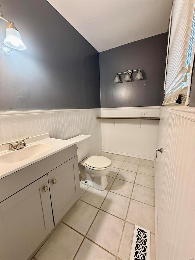 bathroom with vanity, toilet, and tile patterned flooring