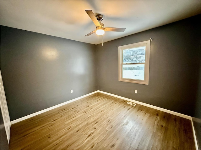 empty room featuring hardwood / wood-style flooring and ceiling fan