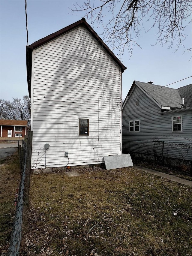 view of side of home featuring a lawn