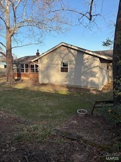 view of side of home featuring a yard