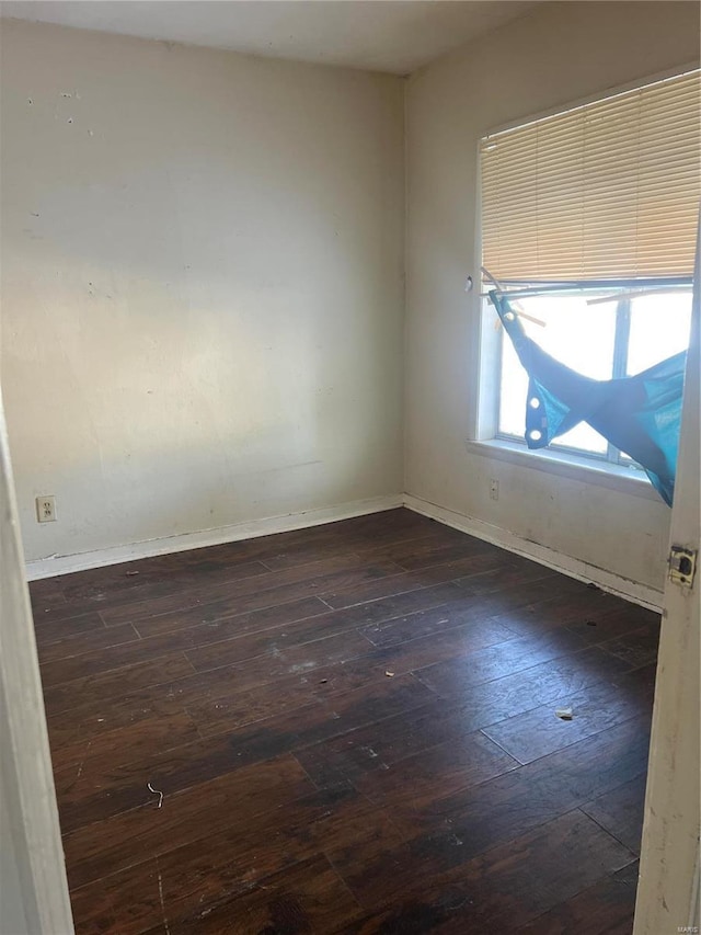 empty room with dark hardwood / wood-style floors