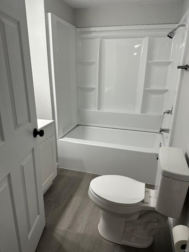 bathroom with vanity, shower / bathing tub combination, wood finished floors, and toilet