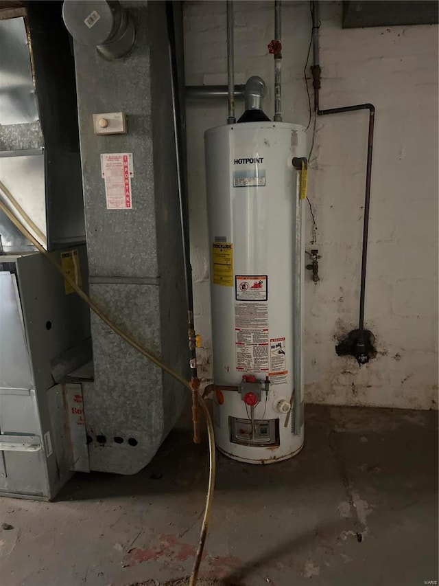 utility room with heating unit and water heater