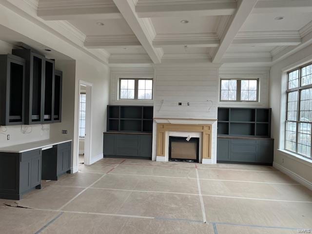 unfurnished living room featuring coffered ceiling, crown molding, and beamed ceiling