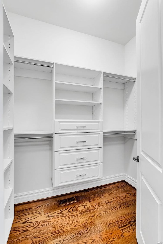 walk in closet featuring visible vents and wood finished floors