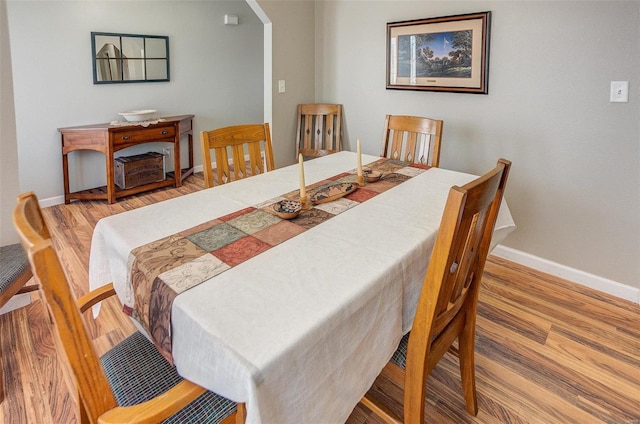 dining space with hardwood / wood-style flooring