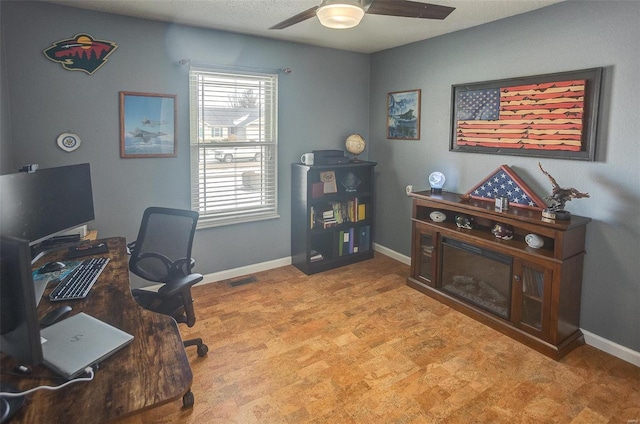 carpeted office with ceiling fan