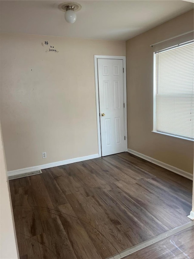 unfurnished room featuring dark hardwood / wood-style floors