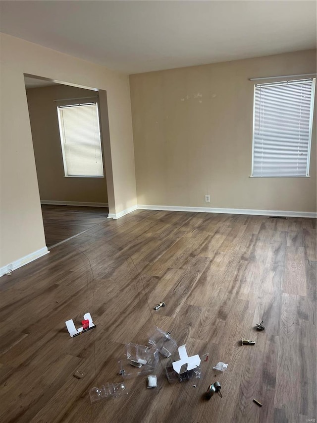 unfurnished room featuring dark wood-type flooring