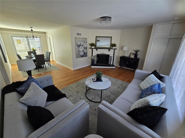 living room with hardwood / wood-style flooring and a fireplace