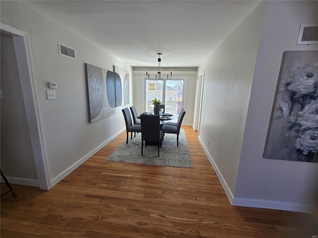 dining space with dark hardwood / wood-style flooring