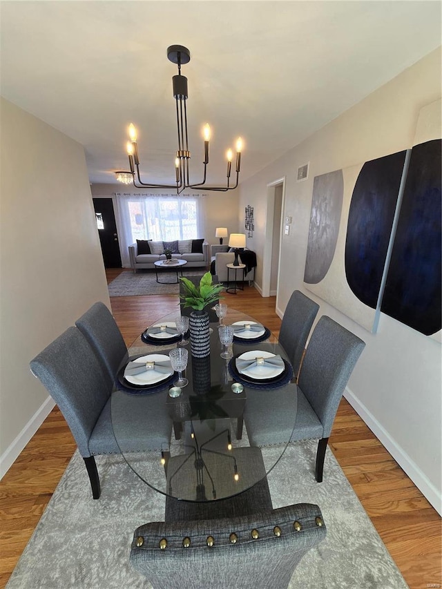 dining room with a notable chandelier and hardwood / wood-style flooring