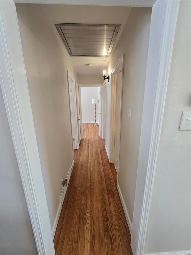 corridor with hardwood / wood-style floors