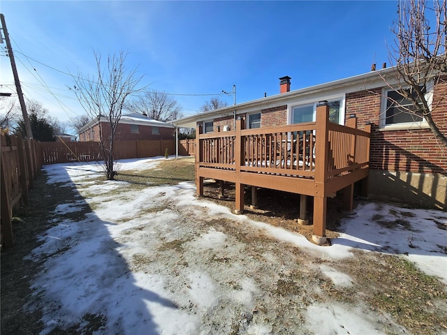 snow covered property with a deck