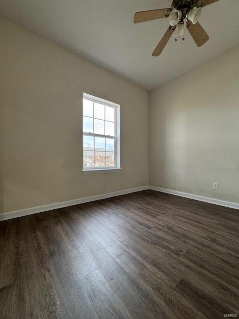 unfurnished room featuring ceiling fan and dark wood-type flooring