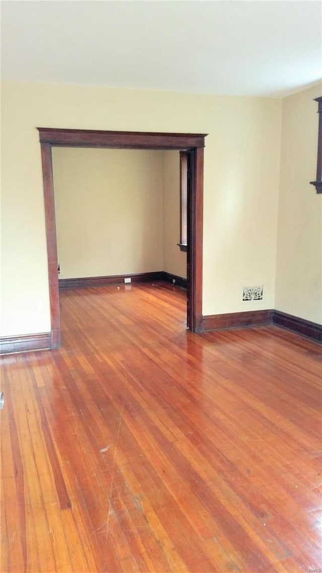 unfurnished room with wood-type flooring