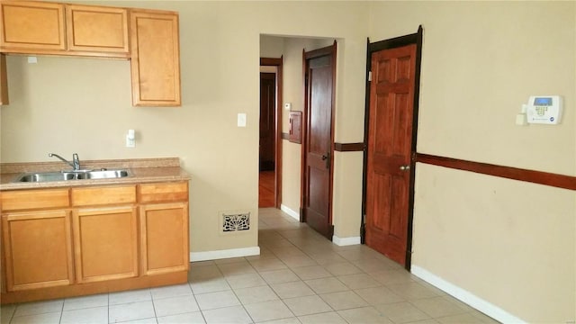 kitchen with sink and light tile patterned floors