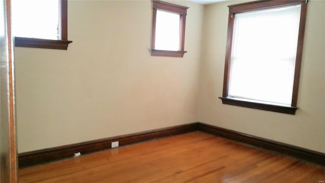 empty room featuring hardwood / wood-style floors and a wealth of natural light