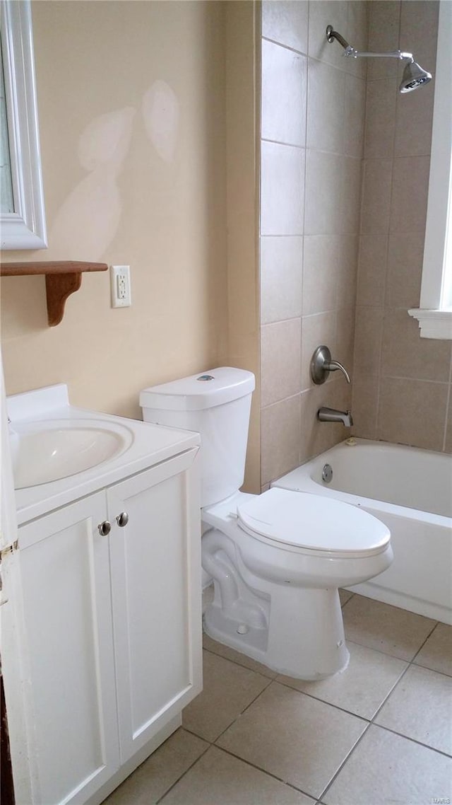 full bathroom featuring vanity, toilet, tiled shower / bath combo, and tile patterned flooring