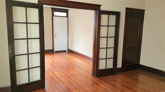 spare room with wood-type flooring