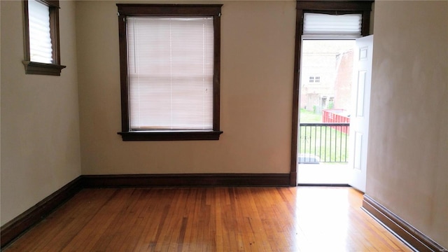 spare room with plenty of natural light and light hardwood / wood-style floors