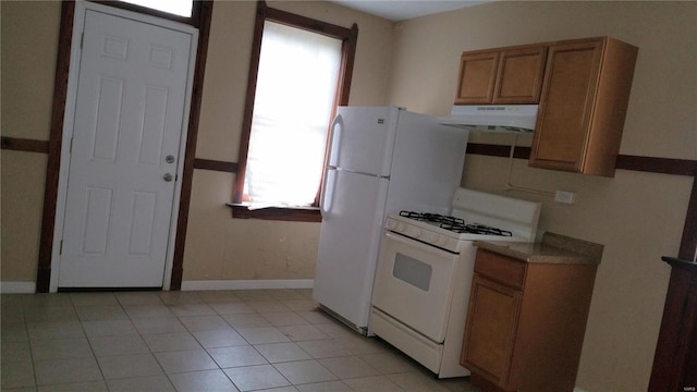 kitchen featuring white range with gas cooktop and light tile patterned flooring