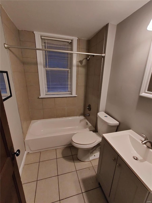 full bathroom with tiled shower / bath combo, tile patterned floors, and toilet