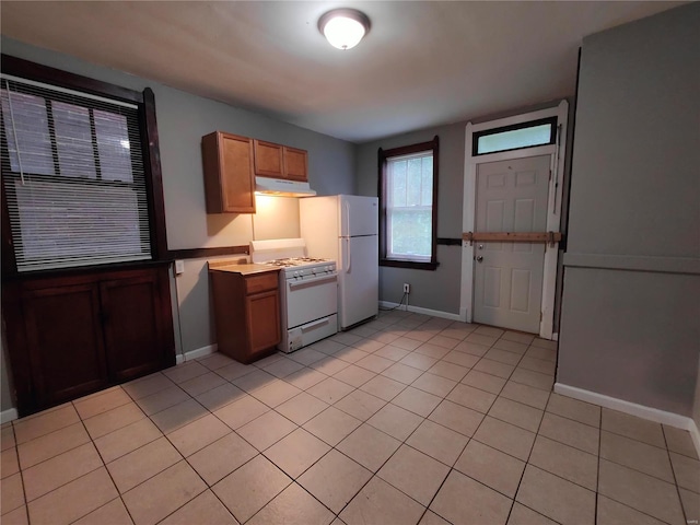 kitchen with light tile patterned floors and white appliances