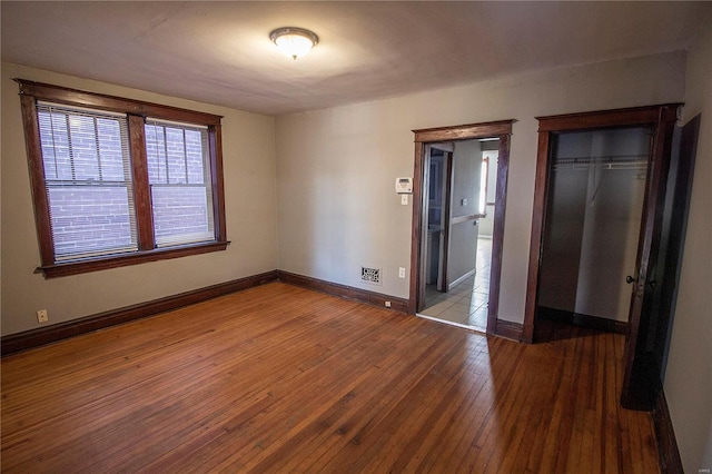 unfurnished bedroom featuring a closet and light hardwood / wood-style flooring