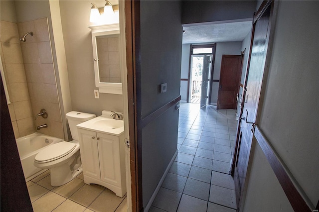 full bathroom featuring tiled shower / bath combo, vanity, tile patterned floors, and toilet